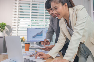 Two experts in a modern Australian conference room analyze charts, discuss strategies and present financial data to plan growth, profits and success.