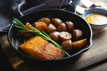 Baked fish with potatoes and rosemary