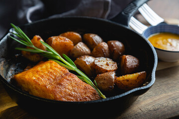 Baked fish with potatoes and rosemary
