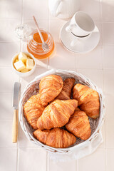 Tasty and healthy french croissants with honey and butter.