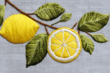 Delicate embroidery of sliced lemon and leaves, precise yellow and green threads on light gray fabric, modern textile art.