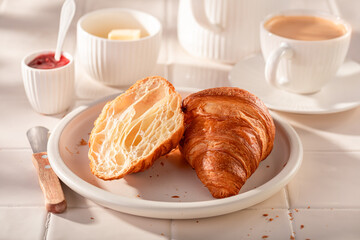 Sweet and healthy french croissants with butter and jam.
