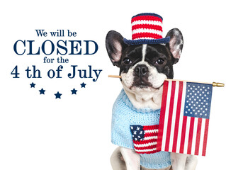 Signboard with the inscription We will be closed for the 4th of July. Cute puppy. Closeup, indoors....