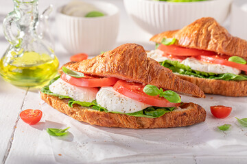 Hot and tasty french croissant with mozzarella and tomatoes.