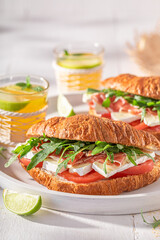 Golden french croissant made of cheese, ham and vegetables.