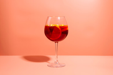 A glass of fruity red cocktail. A refreshing summer drink.