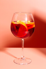 A glass of fruity red cocktail. A refreshing summer drink.