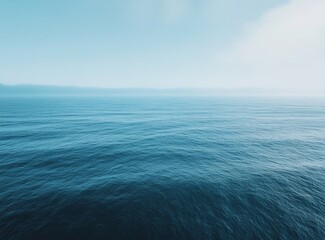 Fototapeta premium Calm Blue Ocean Under a Misty Sky