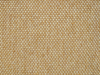 Textured woven fabric in neutral tones highlighting intricate patterns from an indoor environment