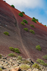Lanzarote, Canary Islands, Spain: the footpath to Montana Colorada, a prominent reddish color...