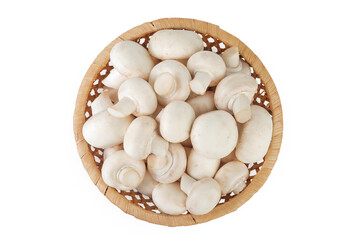 Fresh mushroom champignon in a wicker basket isolated on white background. Top view. Flat lay