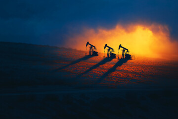 "Desert Pulse" - Aerial view shows synchronized pumpjacks dancing across golden sands, their long morning shadows painting geometric patterns in this minimalist, high-contrast desert landscape.

