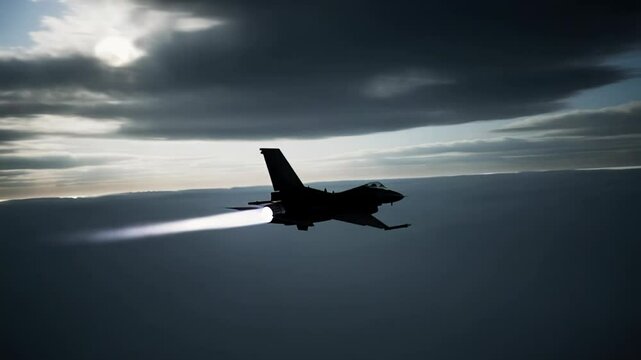 A silhouette of a fighter jet with glowing exhaust flies high in the sky through dramatic clouds. Ideal for military, aviation, speed, and defense themes.