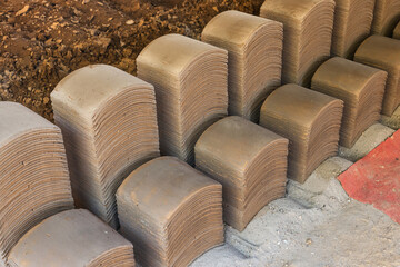 Terracotta clay tiles stacked and arranged in factory