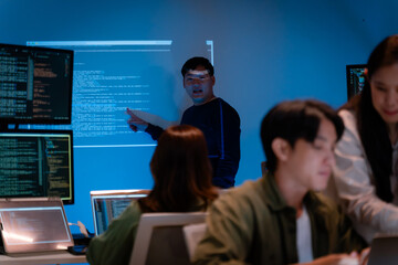 Asian software engineer or programmer team working late in development office,problem solving or algorithm of ai assistant helping for work.software developer,digital technology security concept
