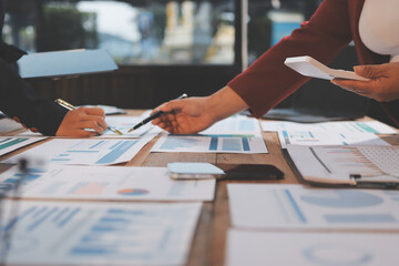 Group of business people brainstorming in analytical plan meeting Calculate the numbers obtained...