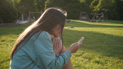 young woman with mobile phone in the park