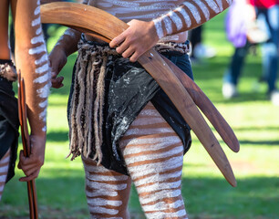 Human hand holds ritual clapsticks for the welcome ritual rite at an indigenous community event in Australia	
