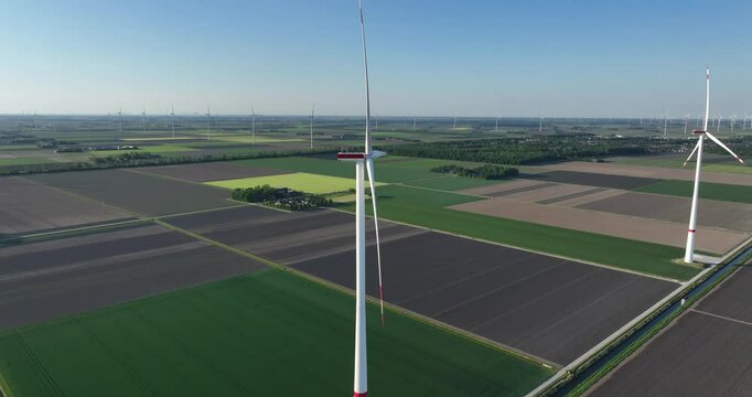 wind turbines in the Flevopolder, symmetrical agricultural fields, power from the wind, wind farms, electricity for households, wind energy, renewable electricity, sustainable energy. Aerial view.