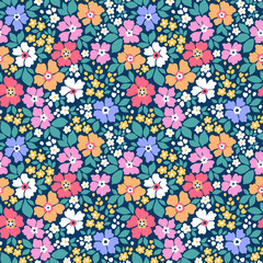 Vector seamless pattern. Bright pattern in small flowers. Small colorful flowers. Dark blue background. Ditsy floral background. Vintage template for fashion prints. Stock vector. Fashion cute print