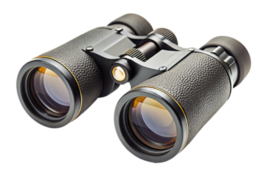 A close up studio shot of a pair of black binoculars with gold accents on a black background surface