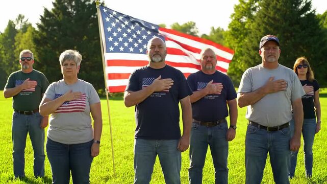 Group pledging allegiance with American flag
