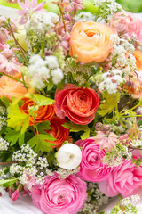 Spring mixed ranunculus bouquet. Beautiful pastel colored fresh flowers arrangement. Birthday bouquet made of ranunculus photographed outdoors.