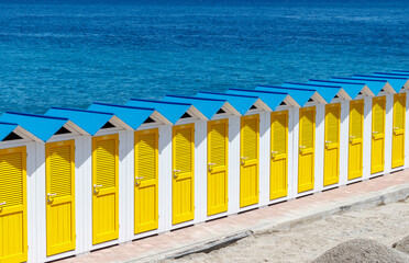 Vintage little beach house or cabins with yellow doors in a row