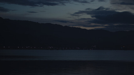 Night Landscape with City Lights and Mountains