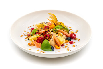 Mixed fruit salad with fruits such as banana, strawberry and pineapple on a white porcelain plate