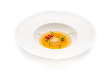 Ravioli consomme on a white porcelain plate. Healthy eating concept