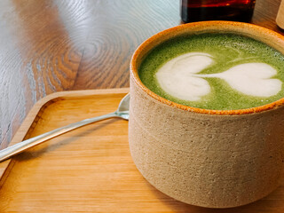 Refreshing matcha drink served in a cozy cafe with a beautiful latte art design