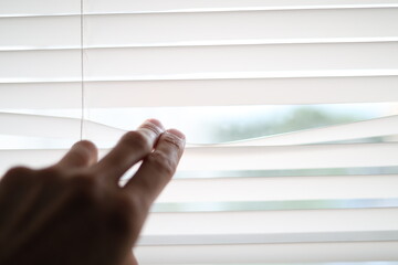 Two finger spread a blind of jalusie on window