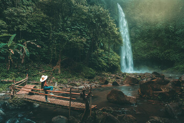 Woman near Nung Nung waterfal on Bali, Indonesia