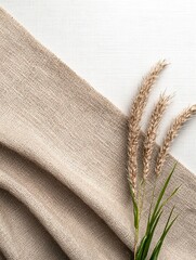 Beige Cotton Fabric with Dried Grass on White Wooden Background