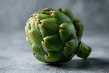 Obraz premium a close up of a green artichoke on a table