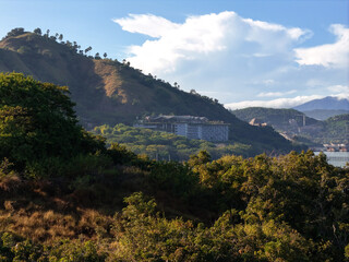 Labuan Bajo, Indonesia - 28 May 2025: Seaside row of luxury beachfront resorts in Labuan Bajo, Indonesia, tropical coastal architecture and ocean view