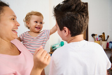 Happy Family Engagement with Cheerful Toddler in a Joyful Home Moment