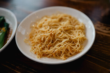 Plate of Chinese Egg Noodles on Wooden Table