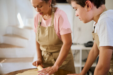 Mother and Son Baking Together in a Cozy Kitchen Setting