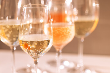 A close-up of glasses with alcoholic beverages. Cups with colorful sparkling wines from different grape varieties