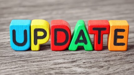 Colorful Wooden Blocks Forming the Word Update on a Textured Wooden Surface for Creative and Educational Use