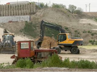 Construction machines operating at a busy site, preparing land for new development