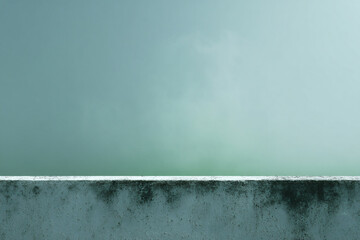 a person standing on a ledge with a surfboard