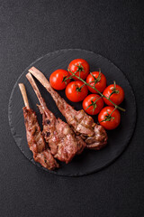 Juicy meat on the bone or rack of lamb. Grilled veal with salt, spices and herbs