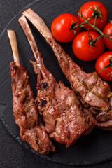 Juicy meat on the bone or rack of lamb. Grilled veal with salt, spices and herbs