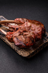 Juicy meat on the bone or rack of lamb. Grilled veal with salt, spices and herbs