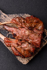 Juicy meat on the bone or rack of lamb. Grilled veal with salt, spices and herbs