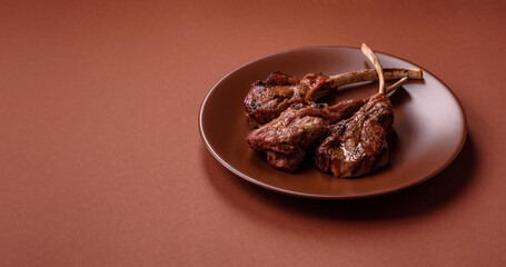 Juicy meat on the bone or rack of lamb. Grilled veal with salt, spices and herbs