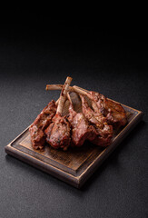 Juicy meat on the bone or rack of lamb. Grilled veal with salt, spices and herbs